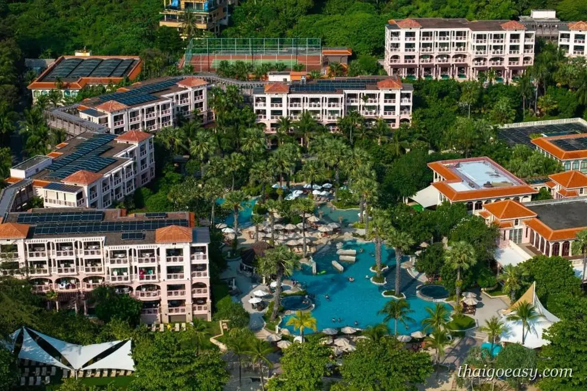 空拍卡倫的盛泰樂豪華海灘度假村，低層建築群圍著大型潟湖式泳池，後方是綠色山丘